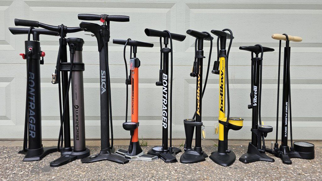 Portable bike pump attached to mountain bike frame for fast tire inflation