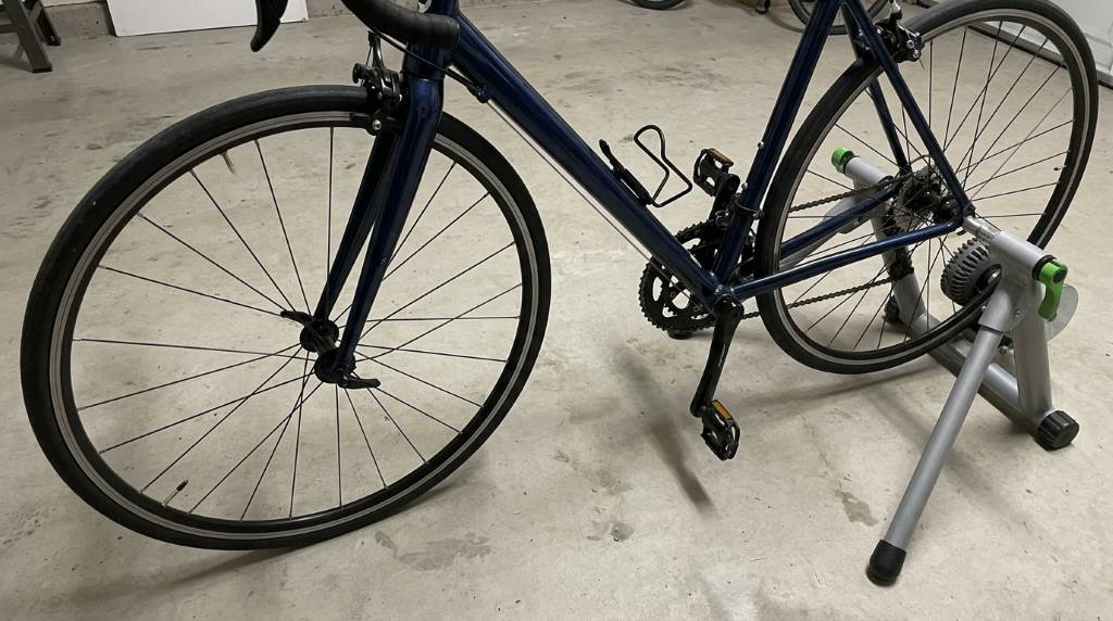 Indoor cycling setup with a front wheel riser block on a trainer