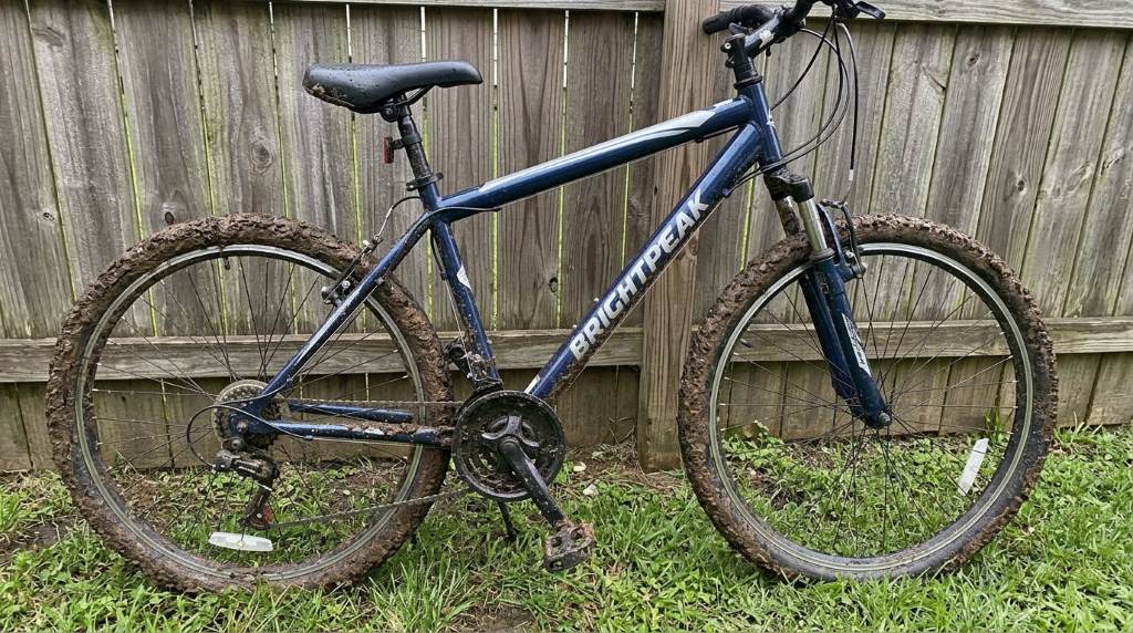 Lubricating the chain of a freshly cleaned Brightpeak 26 Inch Mountain Bike