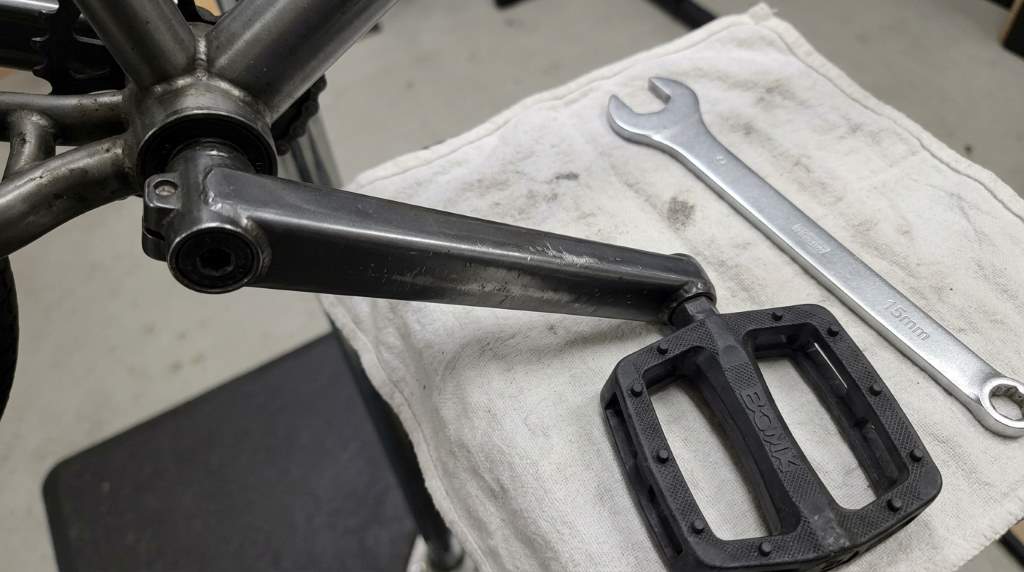 Professional BMX rider checking pedal grip and performance