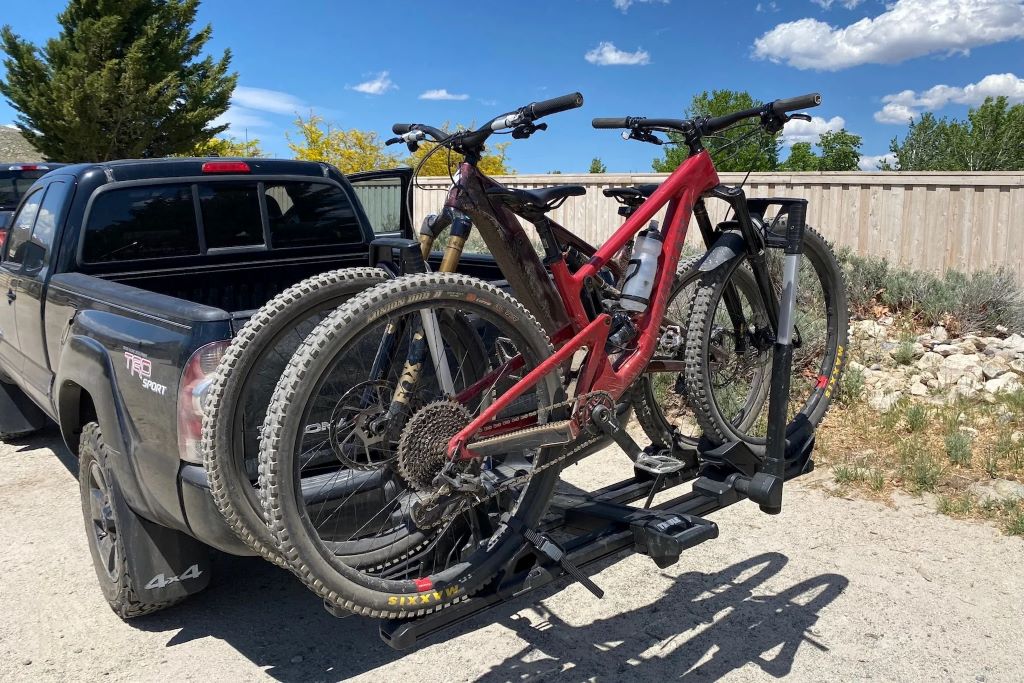 Vehicle transporting bicycles on a hitch bike rack during a family cycling trip outdoors
