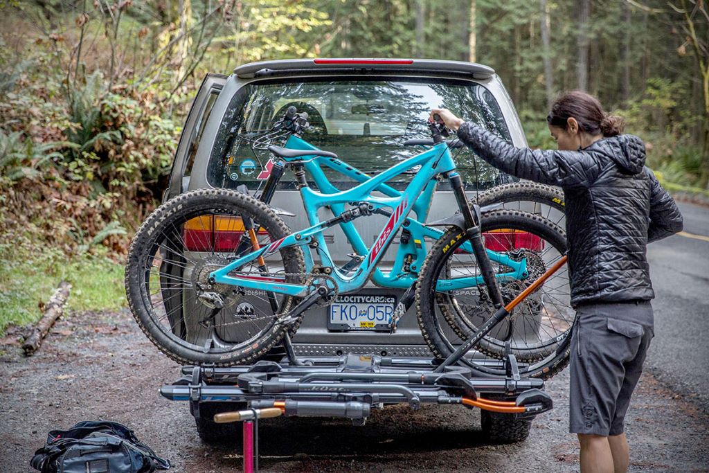 Hitch bike rack mounted on an SUV carrying bicycles securely for safe road transport
